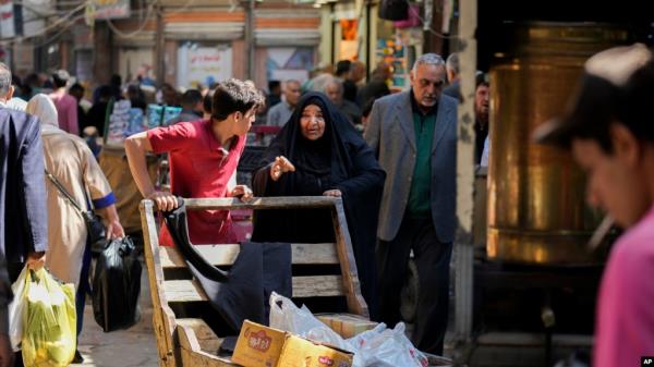 FILE - People shop at a market in Baghdad, Iraq, March. 7, 2024. In late November, the country will conduct its first census in almost three decades.