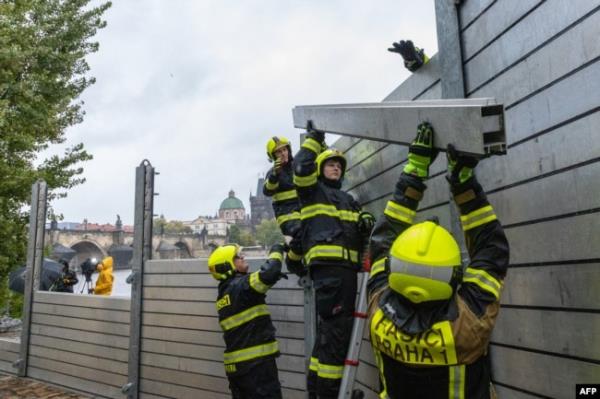 Firefighters build flood barriers on the left bank of the Vlatva River near the Charles Bridge in Prague, Czech Republic, on Sept. 13, 2024.