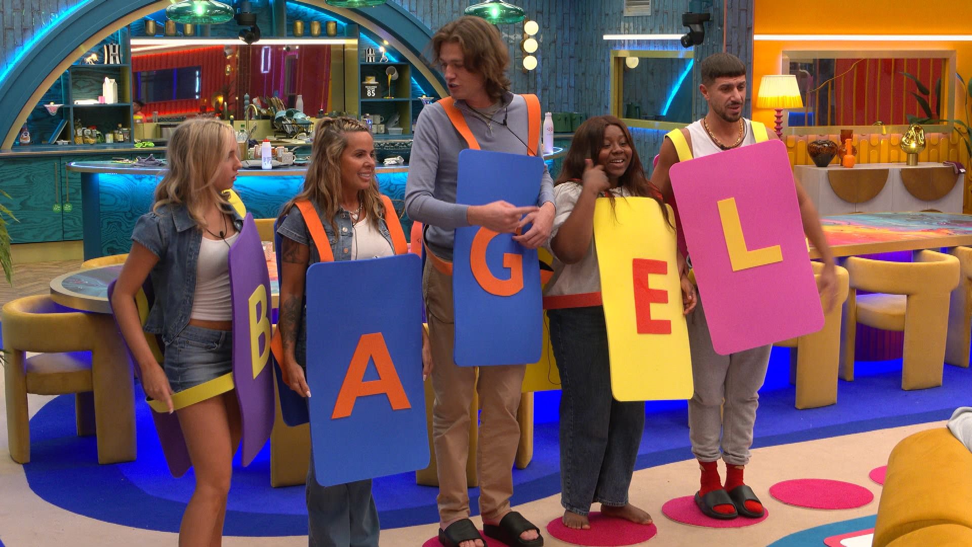 Housemates spell out word 'Bagel' while dressed as letters during episode of Big Brother