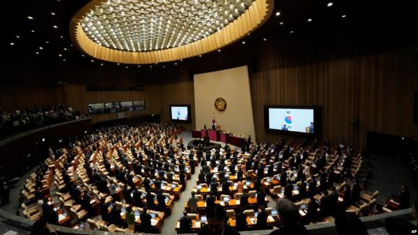 South Korean lawmakers salute their national flag during the opening session of the 22nd National Assembly in Seoul, South Korea, Sept. 2, 2024.
