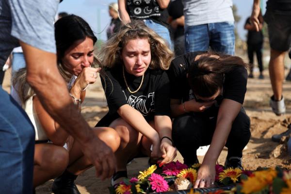 People leaving flowers for the victims of the attack on the festival.
