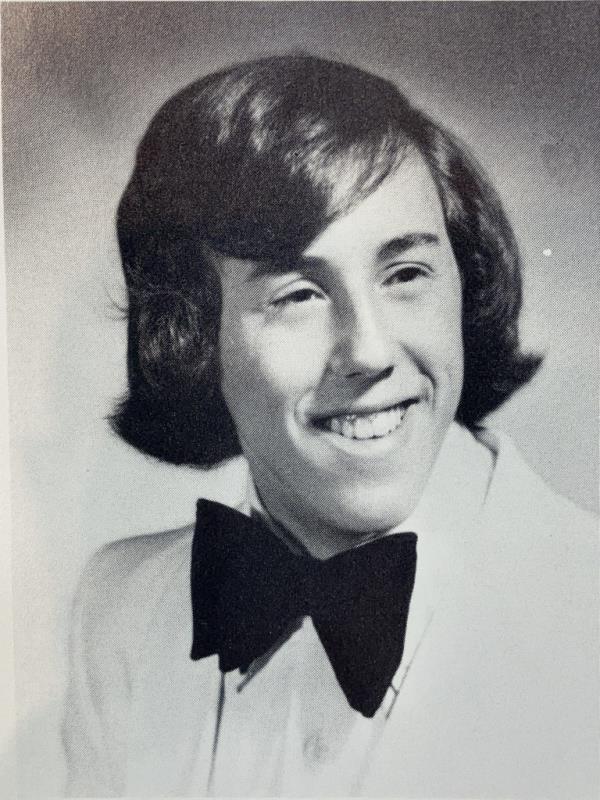 Werdann in high school photo with a white suit jacket and black bow tie