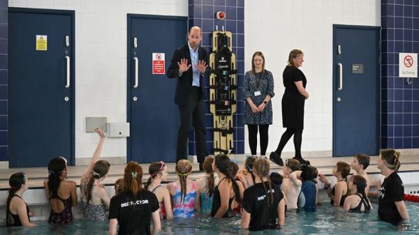 The Prince of Wales speaks with schoolchildren attending a swimming class during a visit to Birtley Community Pool. Pic: PA