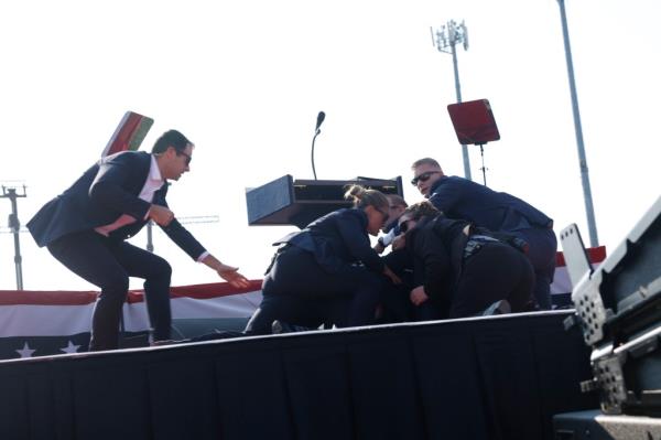 former President Donald Trump is rushed offstage during a rally on July 13, 2024 in Butler, Pennsylvania.