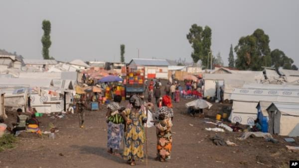 Women walk in the Bulengo refugee camp in Goma, Congo, after the World Health Organization had declared Aug, 15, 2024, the increasing spread of mpox in Africa a global health emergency.