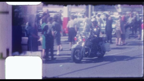 The video contains footage of Kennedy's motorcade driving to the hospital after he was shot.