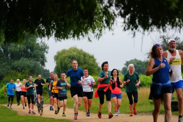People take part in the Park Run at Bushy Park in London