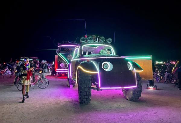 Attendees look at art cars during the festival. 
