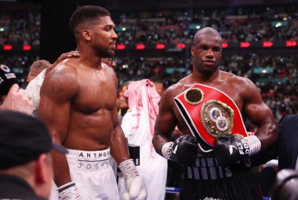 Daniel Dubois and Anthony Joshua react after the IBF World Heavyweight Title fight between Daniel Dubois and Anthony Joshua