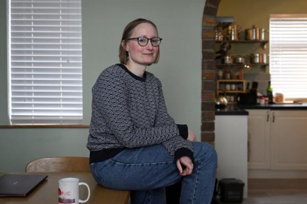 Sophie Korevaar, diagnosed with multiple sclerosis in 2022, poses in her living room in Bristol