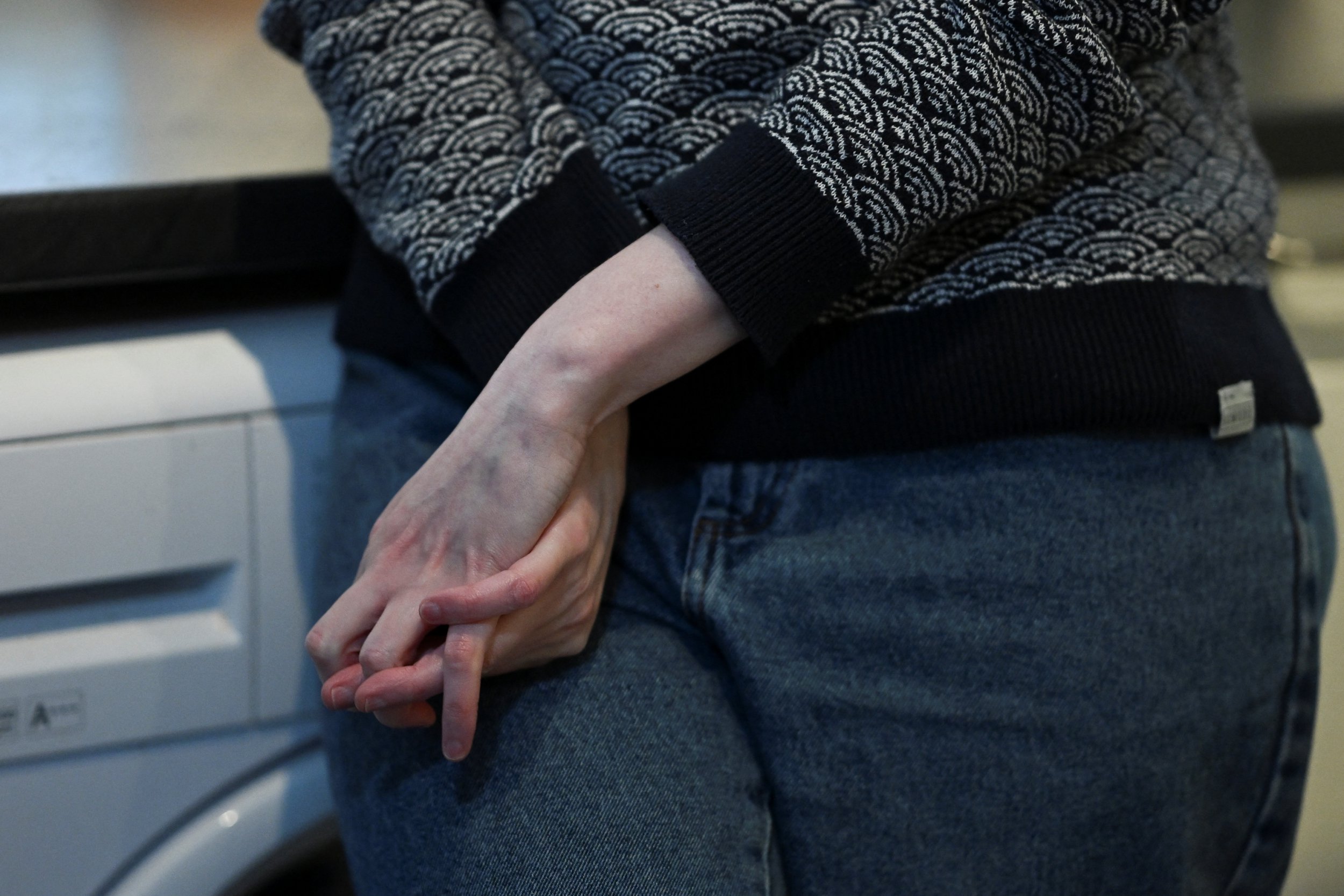Sophie Korevaar, diagnosed with multiple sclerosis in 2022, holds her hands together during an interview at her house in Bristol, Britain October 14, 2024. REUTERS/Jaimi Joy