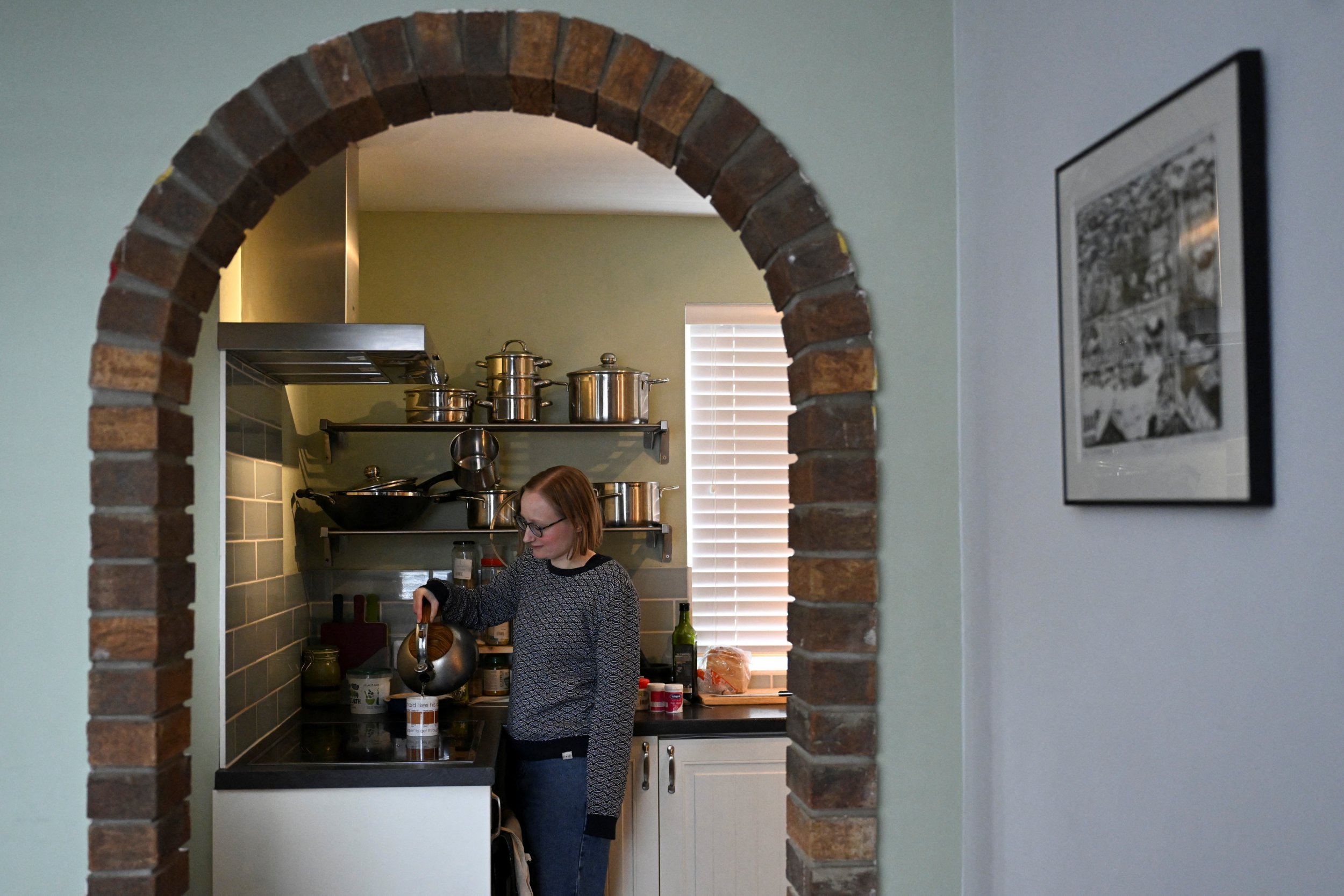 Sophie Korevaar, diagnosed with multiple sclerosis in 2022, poses in her kitchen as she pours the kettle