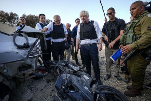 Former UK Prime Minister Boris Johnson, center right, and former Australian Prime Minister Scott Morrison, center left, visit kibbutz Kfar Azza, Israel, Sunday, Nov. 5, 2023. Picture: AP Photo/Ariel Schalit Former UK Prime Minister Boris Johnson, center right, and former Australian Prime Minister Scott Morrison, center left, visit kibbutz Kfar Azza, Israel, Sunday, Nov. 5, 2023. Picture: AP Photo/Ariel Schalit