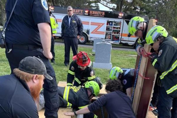 Firefighters rescue man from grave