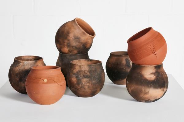 A group of 60 glazed earthenware pots by South African artist Andile Dyalvane, each approximately 8 1/4 x 8 1/2 x 8 1/2 inches in size