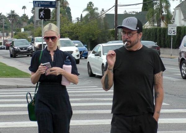 Dave Grohl smokes nonchalantly alongside his wife Jordyn Blum during an outing in Los Angeles.