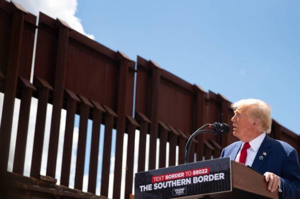 Former President Donald J. Trump speaking into a microphone at the border at Montezuma Pass
