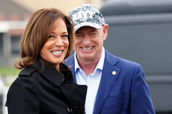 Democratic presidential nominee Vice President Kamala Harris smiles next to Sen. Mark Kelly, D-Ariz., as she departs for the U.S.-Mexico border from Joint base Andrews, Md., Friday, Sept. 27, 2024.