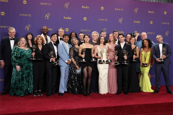 A group of celebrities including Christopher McDonald, Guy Branum, Paul W. Downs, Mark Indelicato, Jean Smart, Carol Leifer, Rose Abdoo, Joe Mande, Michael Schur, Lucia Aniello, David Miner holding trophies