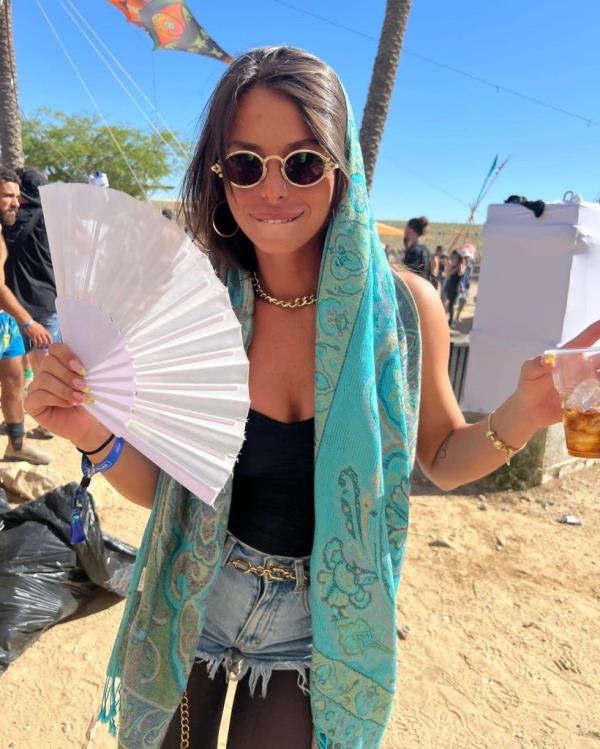 oriya richardo on the beach with a fan