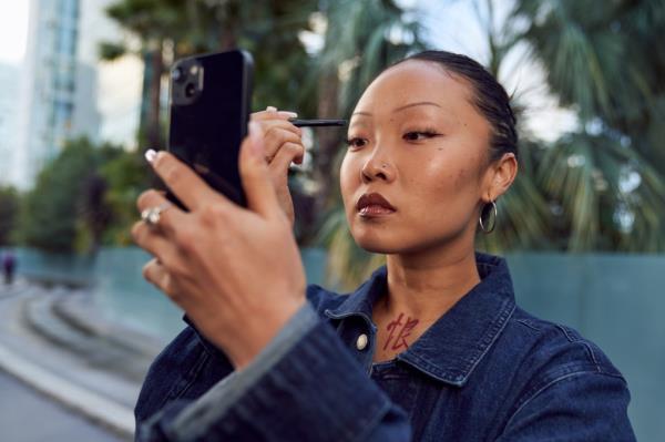 Woman applying eye makeup