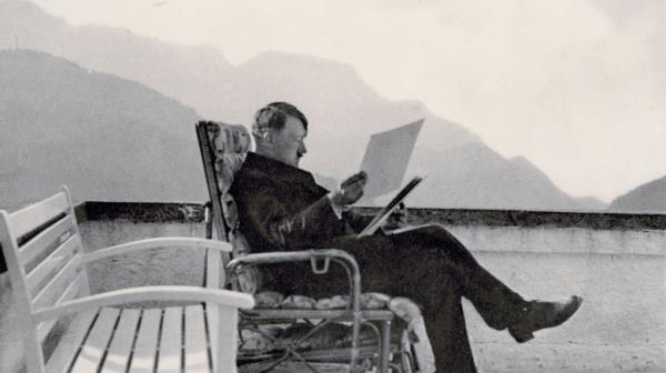 Adolf Hitler at table with food and wine