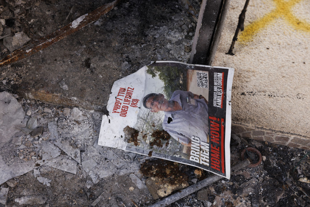 A poster of hostage Oded Lifschitz, kidnapped from his home by Hamas militants, on the floor of his destroyed house in Kibbutz Nir Oz
