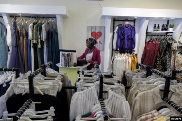 FILE - A woman works in a women's clothing store in Benghazi, Libya, June 19, 2021.