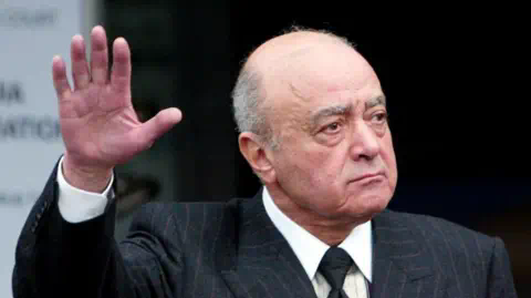 Reuters Mohamed Al Fayed holds up his hand