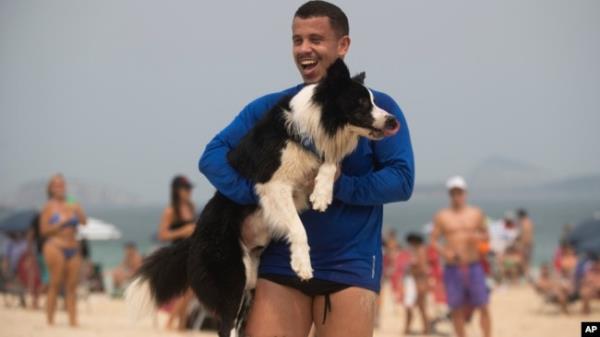 Coach Gustavo Rodrigues celebrates a point with his trainee — a border collie named Floki — as they play footvolley, a combination of soccer and volleyball, in Rio de Janeiro, Sept. 8, 2024.