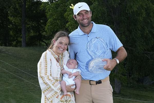 Scottie Scheffler, right, poses for a photo with his wife Meredith, left, son Bennett and the Memorial tournament trophy after winning the Memorial golf tournament, Sunday, June 9, 2024, in Dublin, Ohio. (AP Photo/Sue Ogrocki) Scottie Scheffler, right, poses for a photo with his wife Meredith, left, son Bennett and the Memorial tournament trophy after winning the Memorial golf tournament, Sunday, June 9, 2024, in Dublin, Ohio. (AP Photo/Sue Ogrocki)