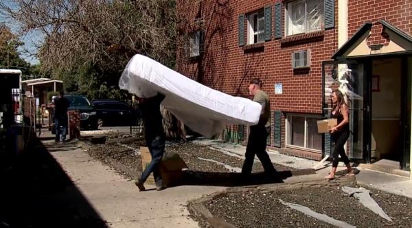 A local city councilwoman, Danielle Jurinsky, alongside congressional candidate John Fabbricatore help move out a resident from an apartment complex taken over by the Venezuelan gang.