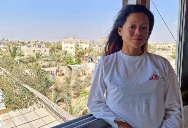 Canadian nurse Amy Kit-Mei Lowe standing on a balcony in Gaza. Lowe works with Doctors Without Borders at Nasser Hospital in Khan Younis. She says the facility is struggling to treat the influx of critically injured patients because supplies are quickly dwindling.