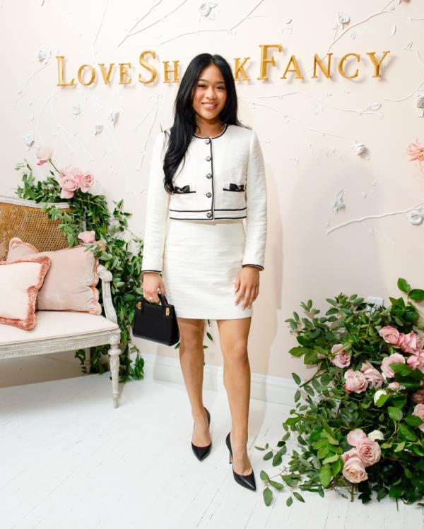 Sunisa Lee in a white dress at the LoveShackFancy SS25 NYFW event