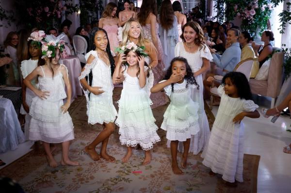 Designer Rebecca Hessel Cohen and child models wearing white dresses at the LoveShackFancy runway show, New York Fashion Week, September 2024