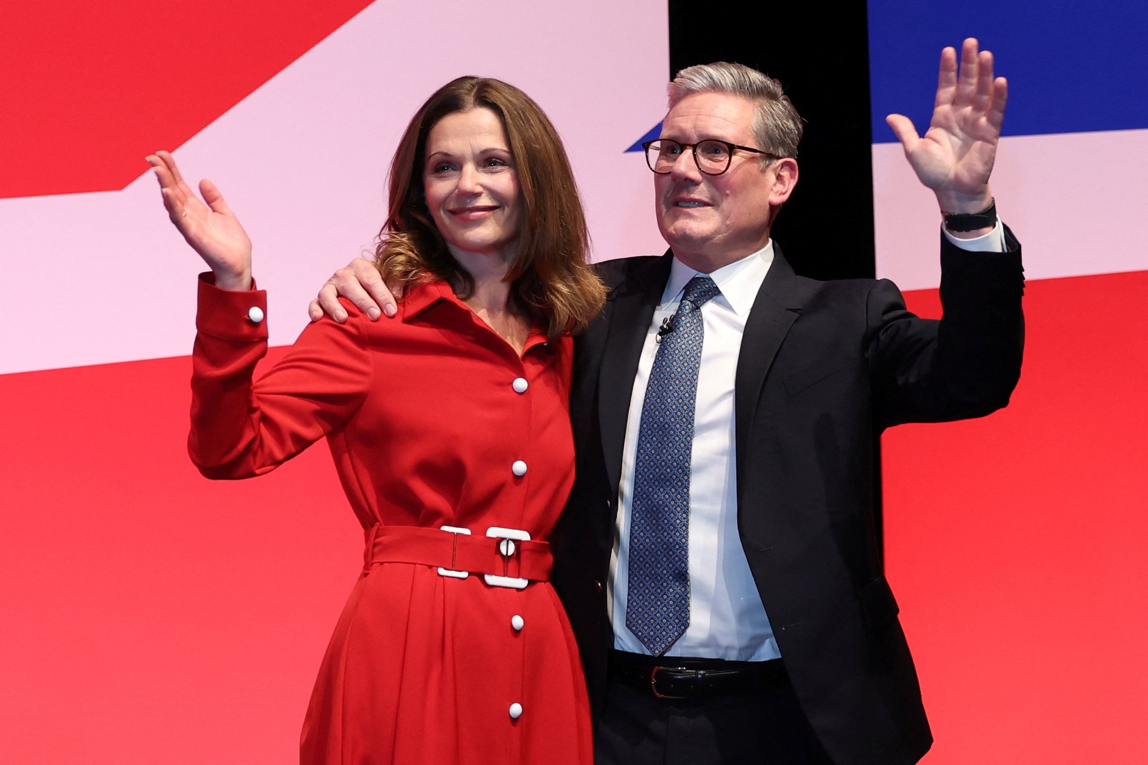 British Prime Minister Keir Starmer and his wife Victoria Starmer wave from the stage at Britain's Labour Party's annual conference=