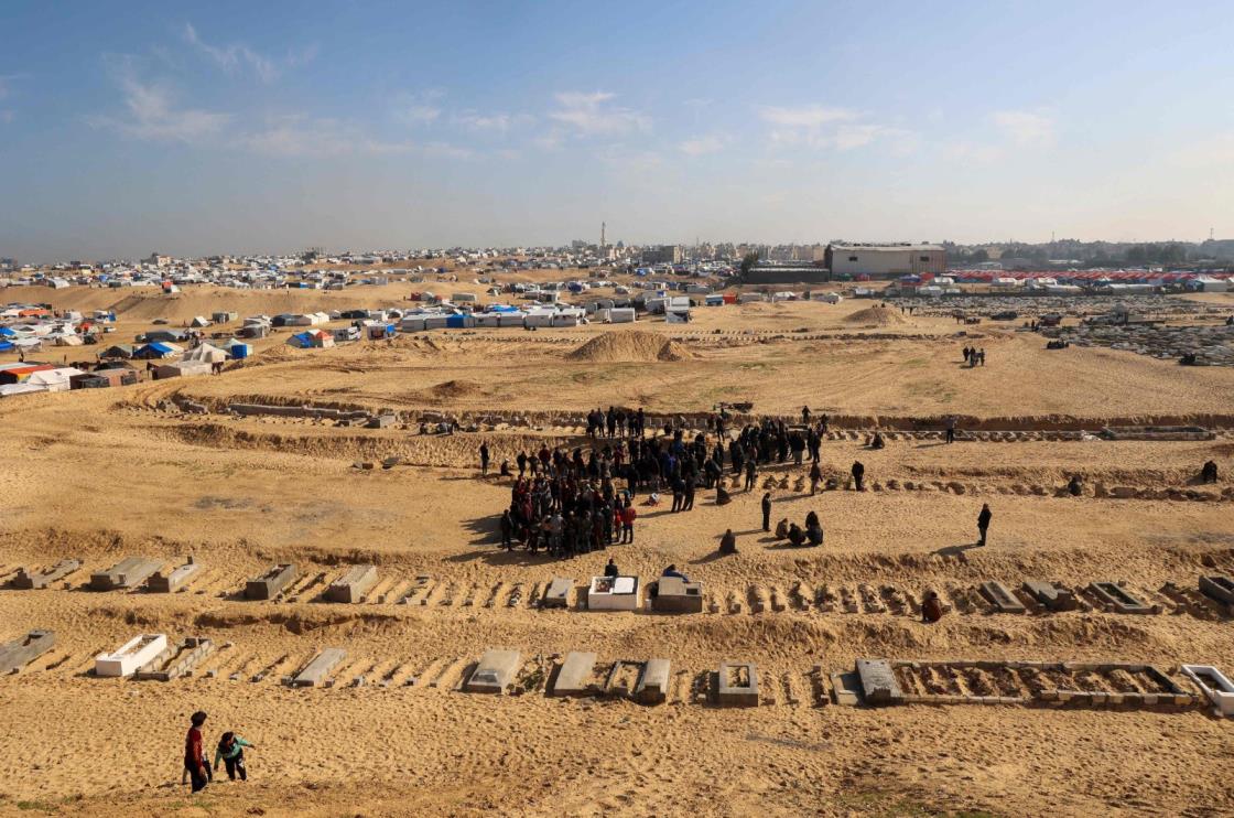 People bury their dead who were killed during overnight Israeli strikes, at a cemetery in Rafah, on the southern Gaza Strip on Feb. 21, 2024. (AFP File Photo)