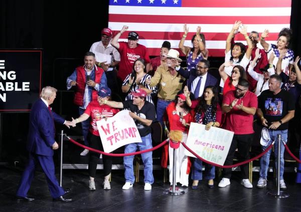 Rodriguez (fourth from the left) is seen greeting Trump on stage at the rally.