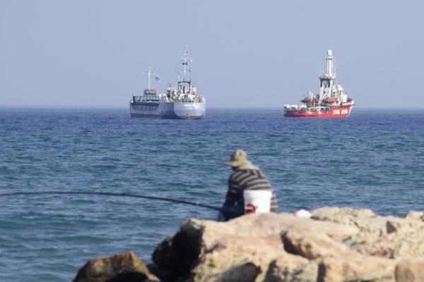 An Open Arms ship and ship Jennifer, of the World Central Kitchen carrying food aid for the Gaza Strip, prepare to set sail close to the port of Larnaca in Cyprus on March 30, 2024. (File/AFP)