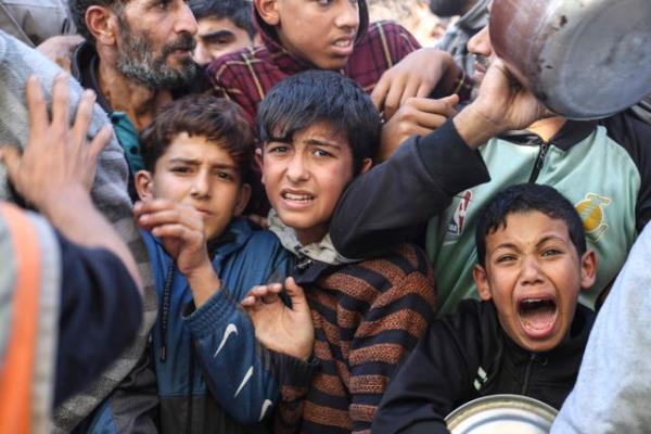 Palestinians line up for food in Rafah
