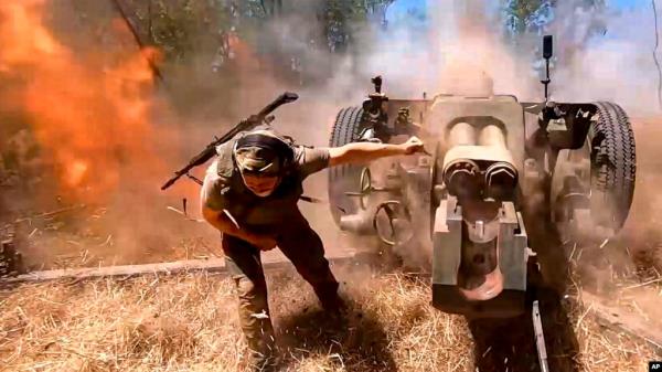 In this image taken from a video distributed by the Russian Defense Ministry on Aug. 22, 2024, a Russian soldier fires a D-30 toward Ukrainian positions in an undisclosed location in Ukraine.