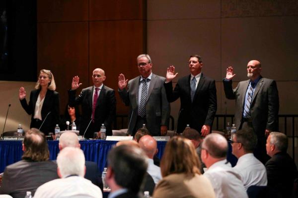 Witnesses are sworn in during a National Transportation Safety Board hearing.