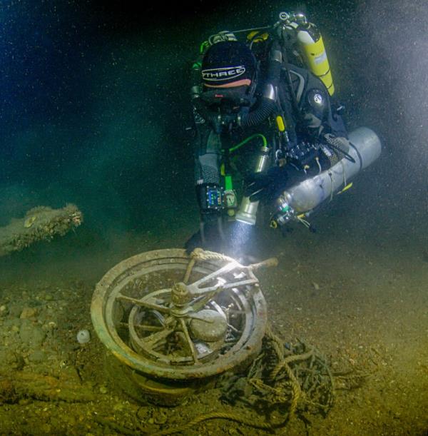  A diver with one of the Lusitania's bridge telegraphs used to communicate with crew in the engine room. Picture: Barry McGill/Indepth Technical Diving.