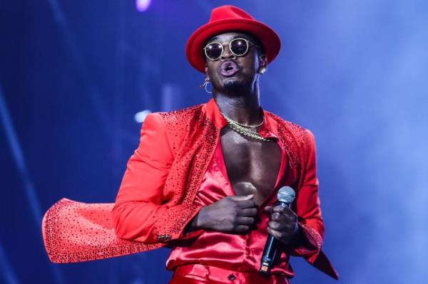 Diddy appears in red suit on stage