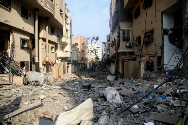 Palestinian citizens inspect damage to their homes.