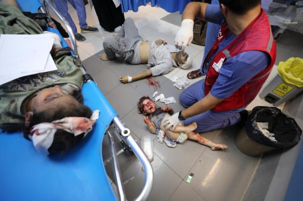 Palestinians wounded in Israeli strikes are brought to Shifa Hospital.