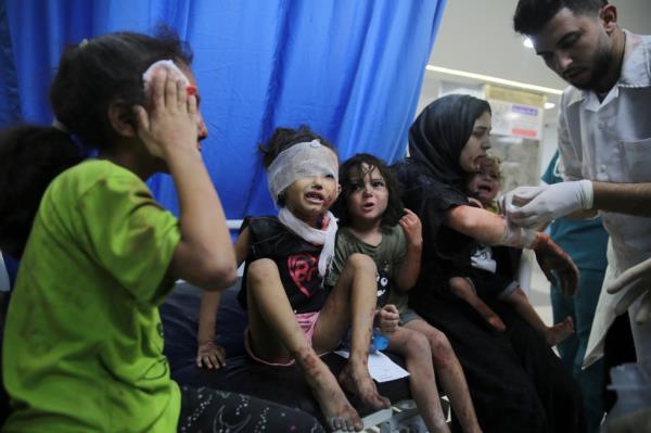 Palestinian children wounded in Israel strikes are brought to Shifa Hospital in Gaza City.
