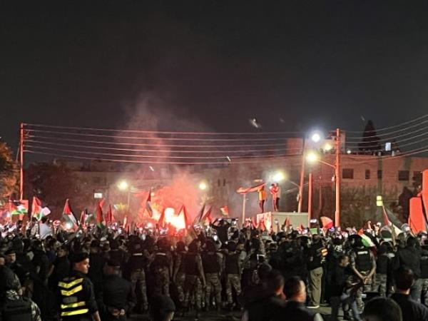 People holding Palestinian flags gather in front of Israeli Embassy to protest against the bombing of Gaza's Al-Ahli Baptist Hospital