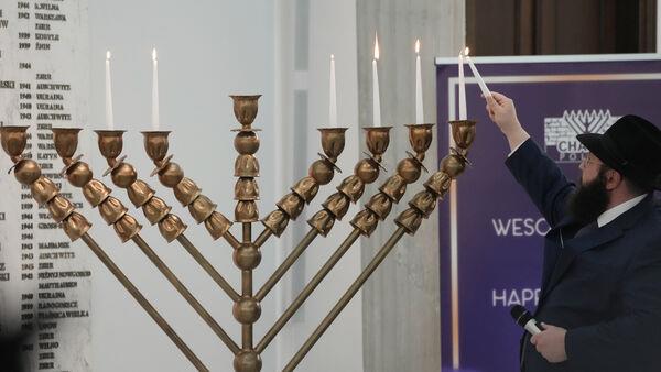 Far-right lawmaker extinguishes Hanukkah candles in Polish parliament