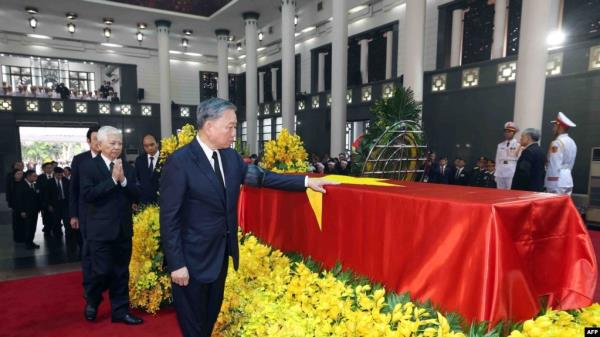 This picture taken and released by the Vietnam News Agency (VNA) on July 25, 2024 shows Vietnamese President To Lam paying his respects for the late general secretary of the Communist Party Nguyen Phu Trong in Hanoi.